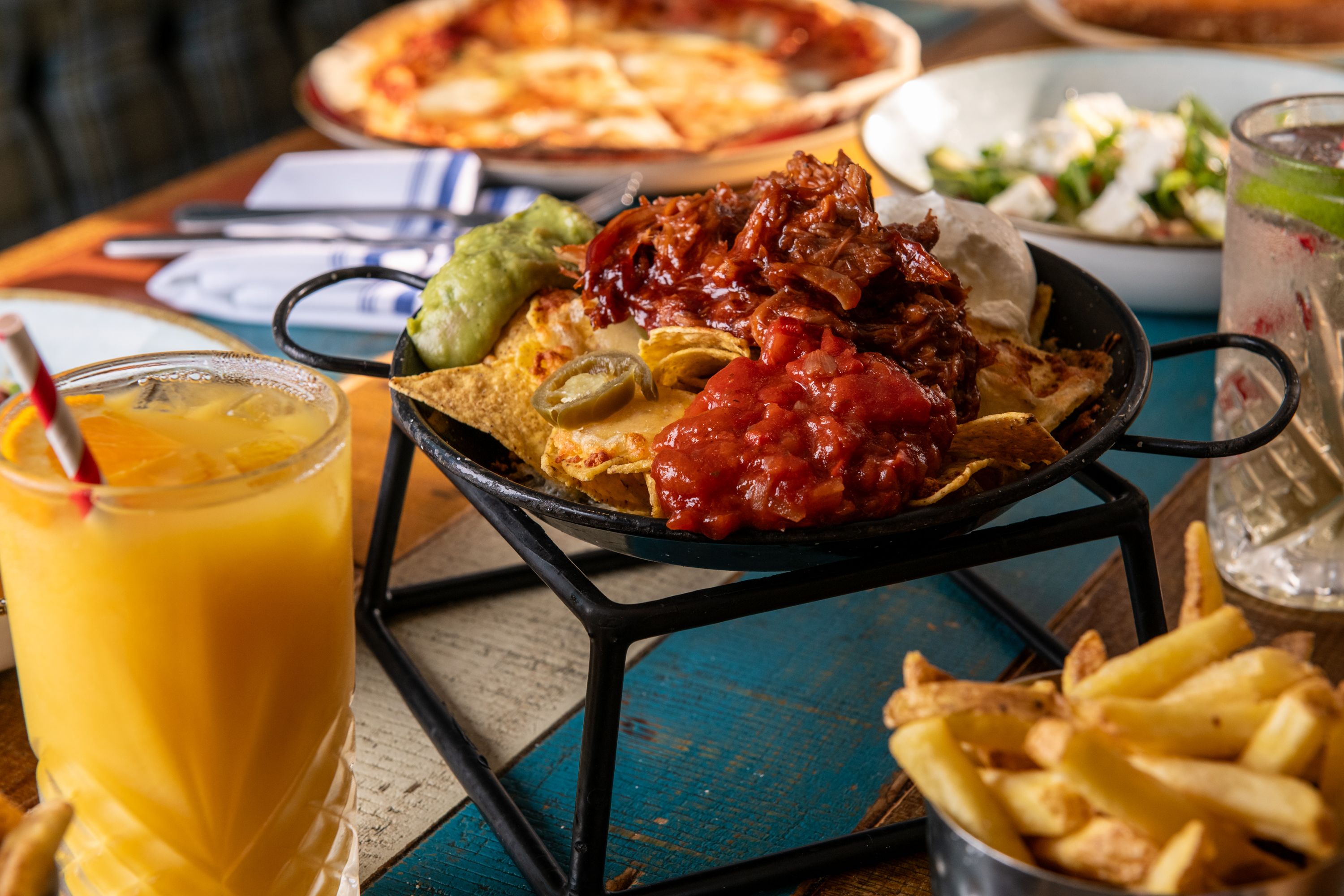 Nachos with salsa, chilli, sour cream, guacamole