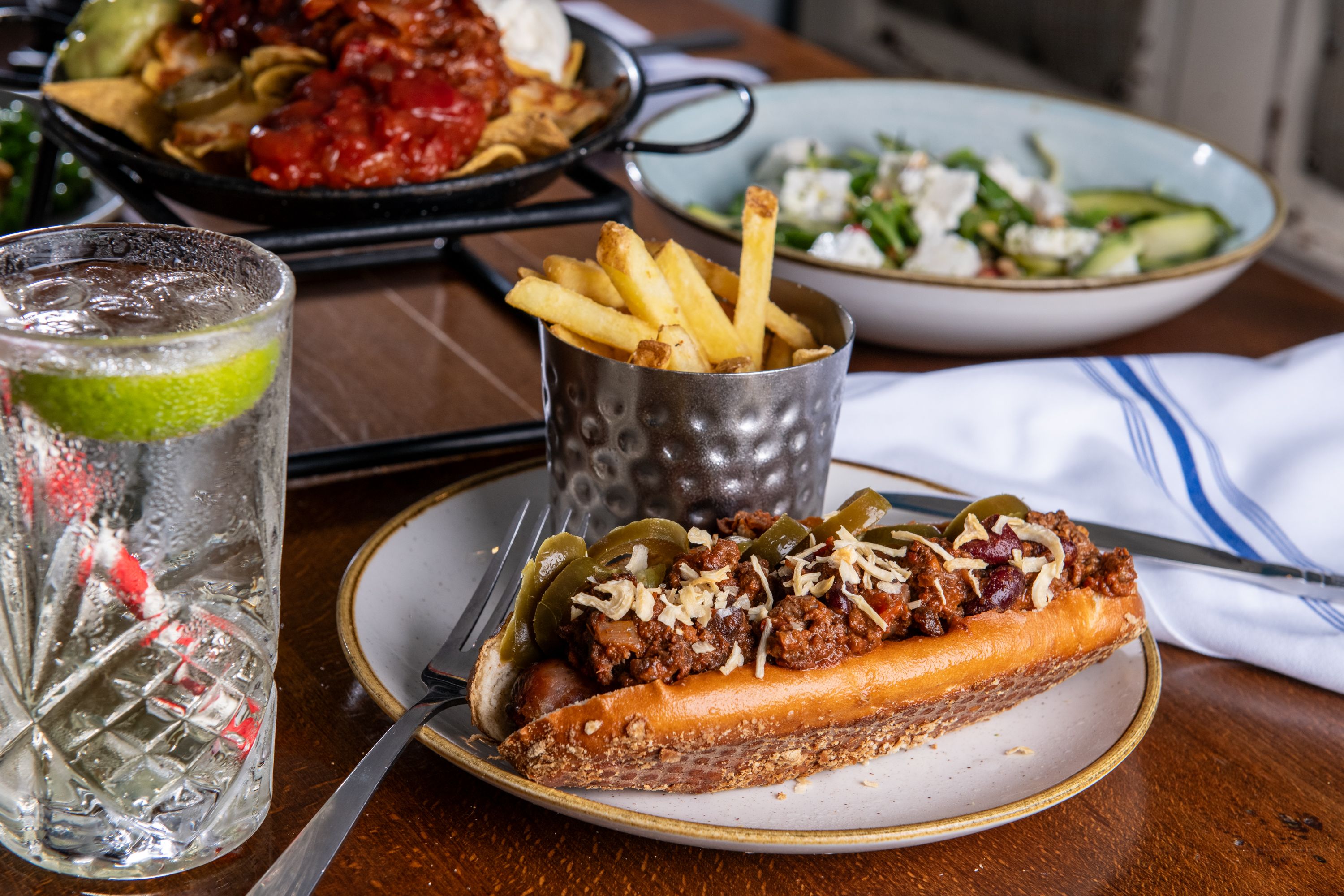 Chilli hotdog meal with chips
