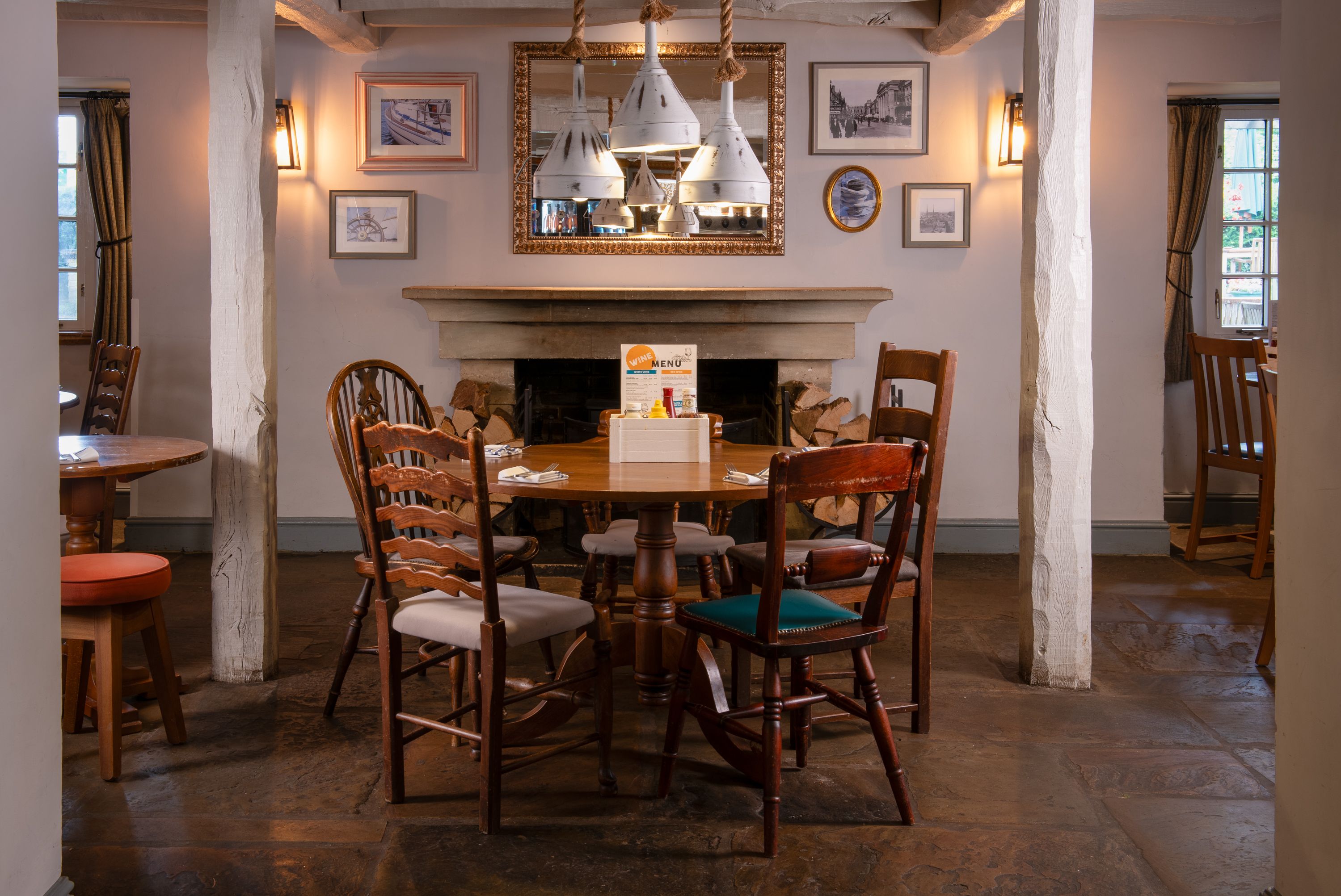 Round table and chairs set up for 4 in front of the fireplace