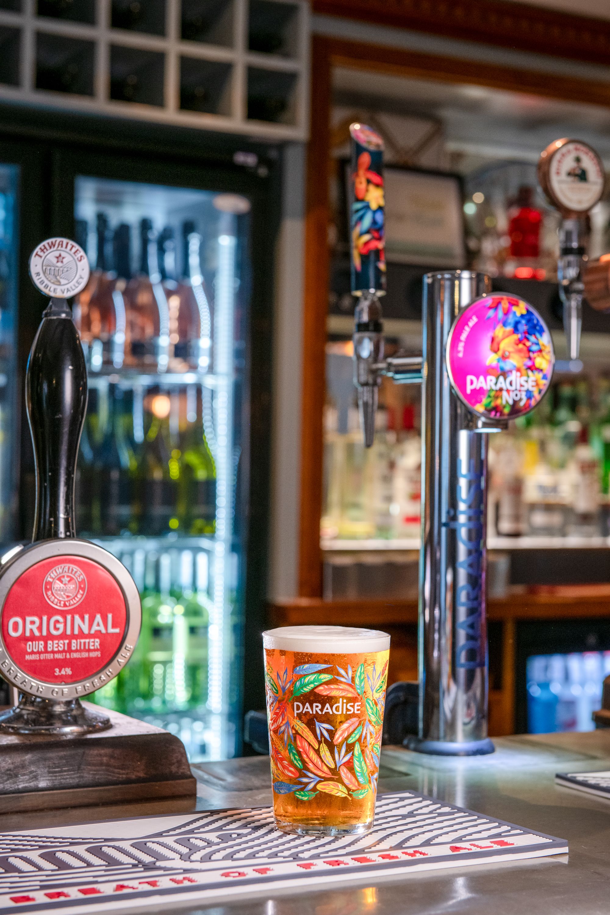 Pint of Paradise on bar in front of paradise pump