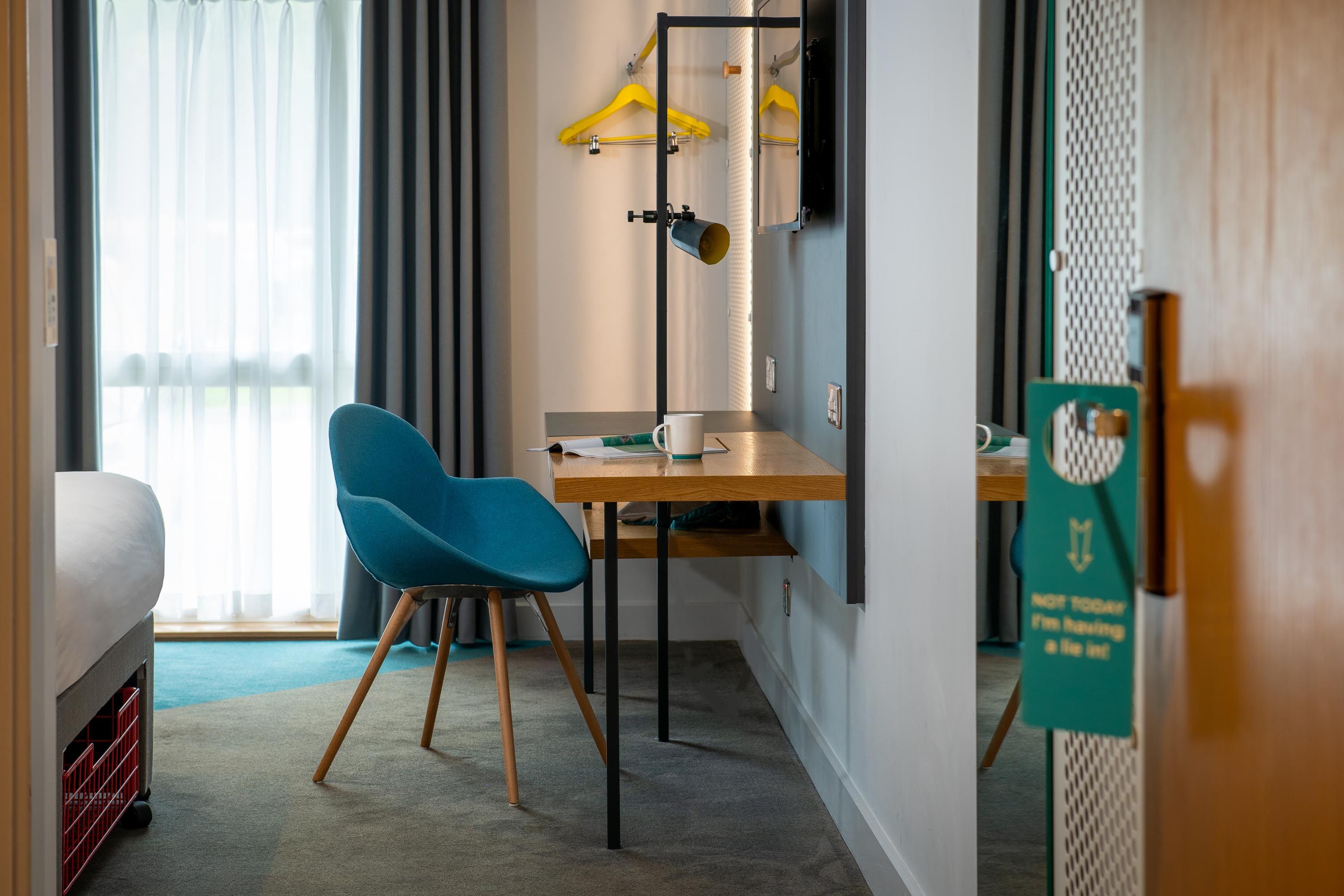 Desk in bedroom with blue chair